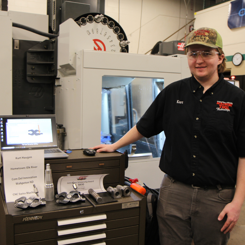 Machine Tool Student stands next to project