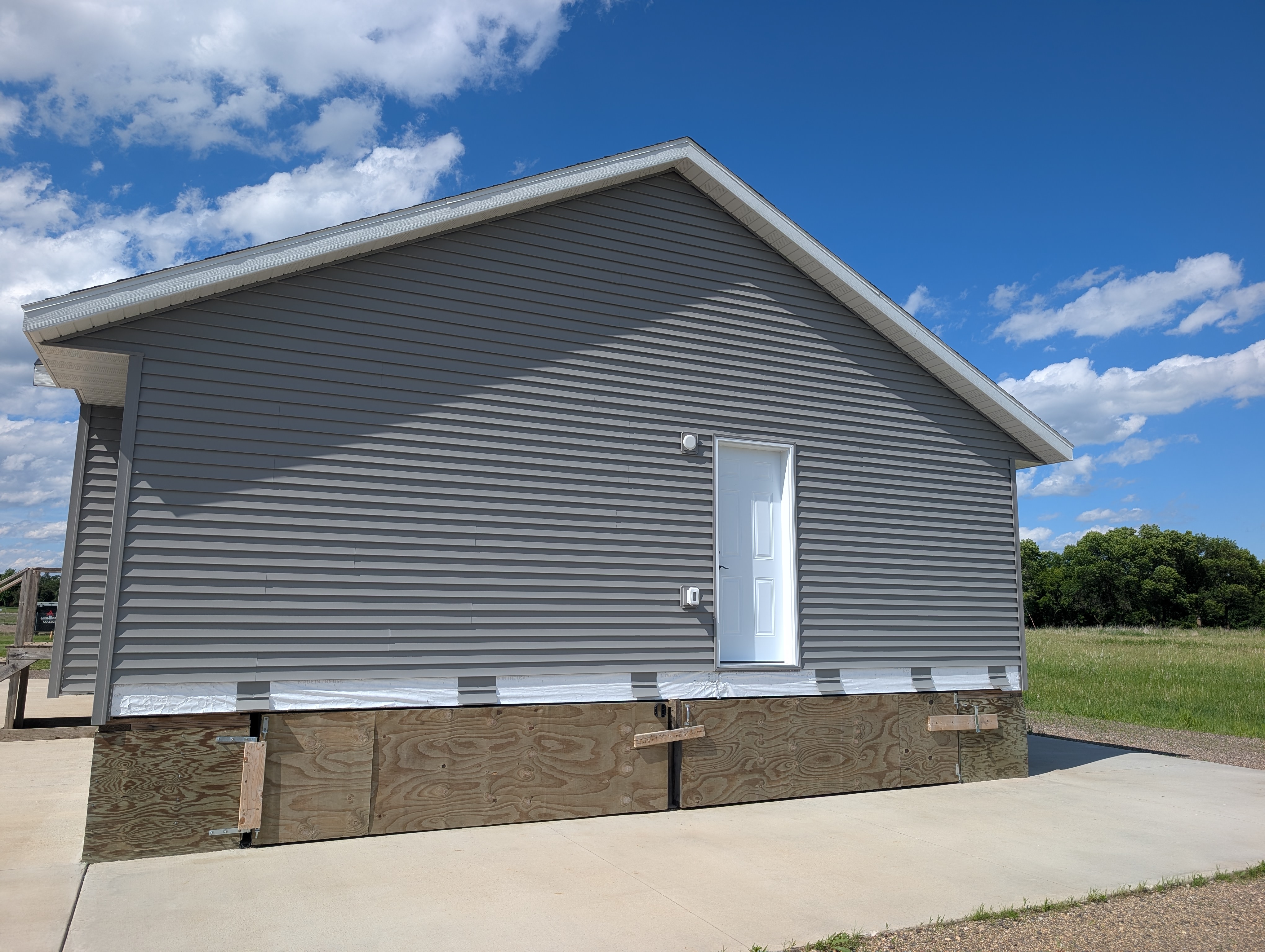 Side of house, with exterior access door.