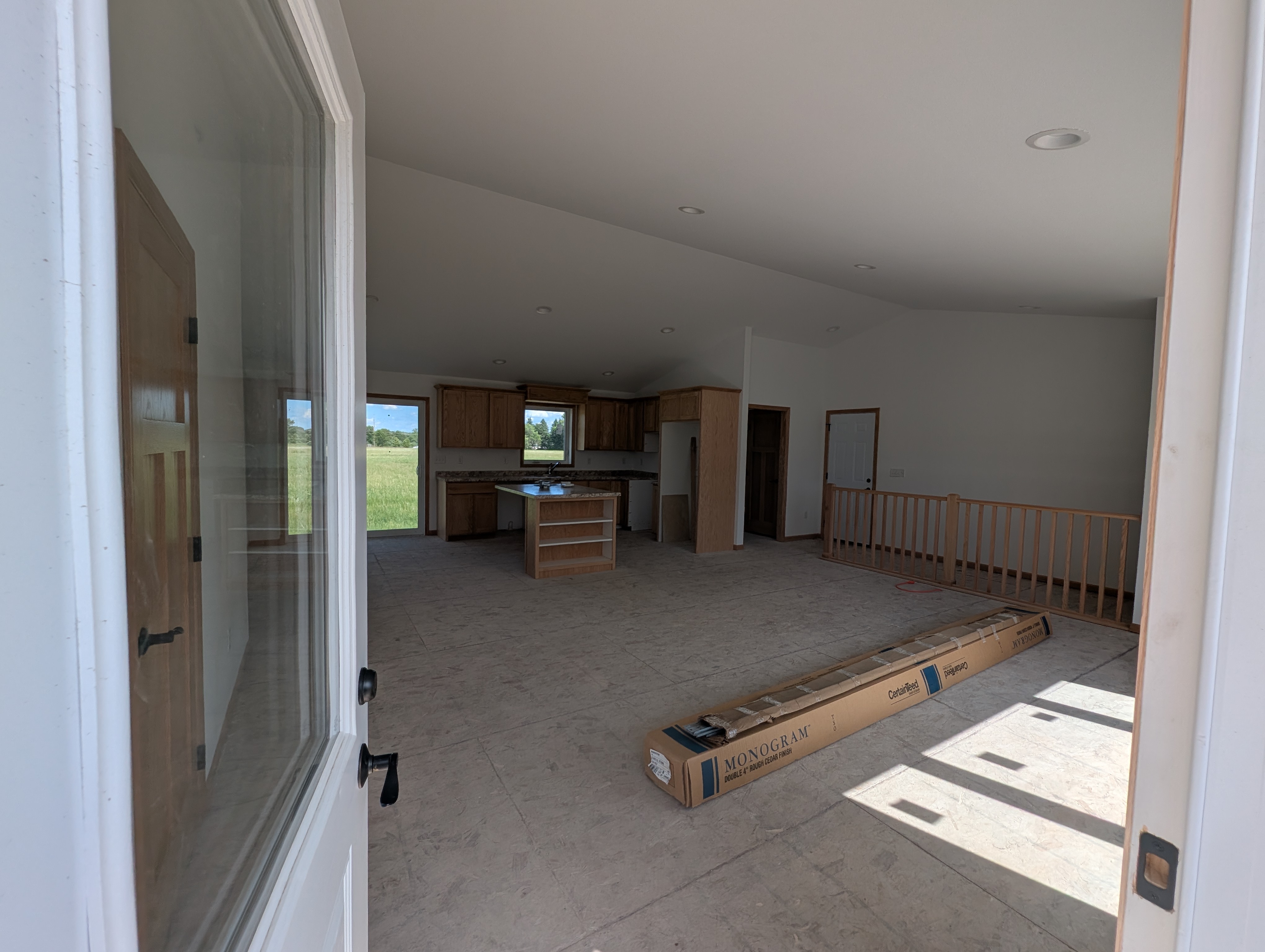 Opening the front door to an open concept living room, kitchen, and dining area.