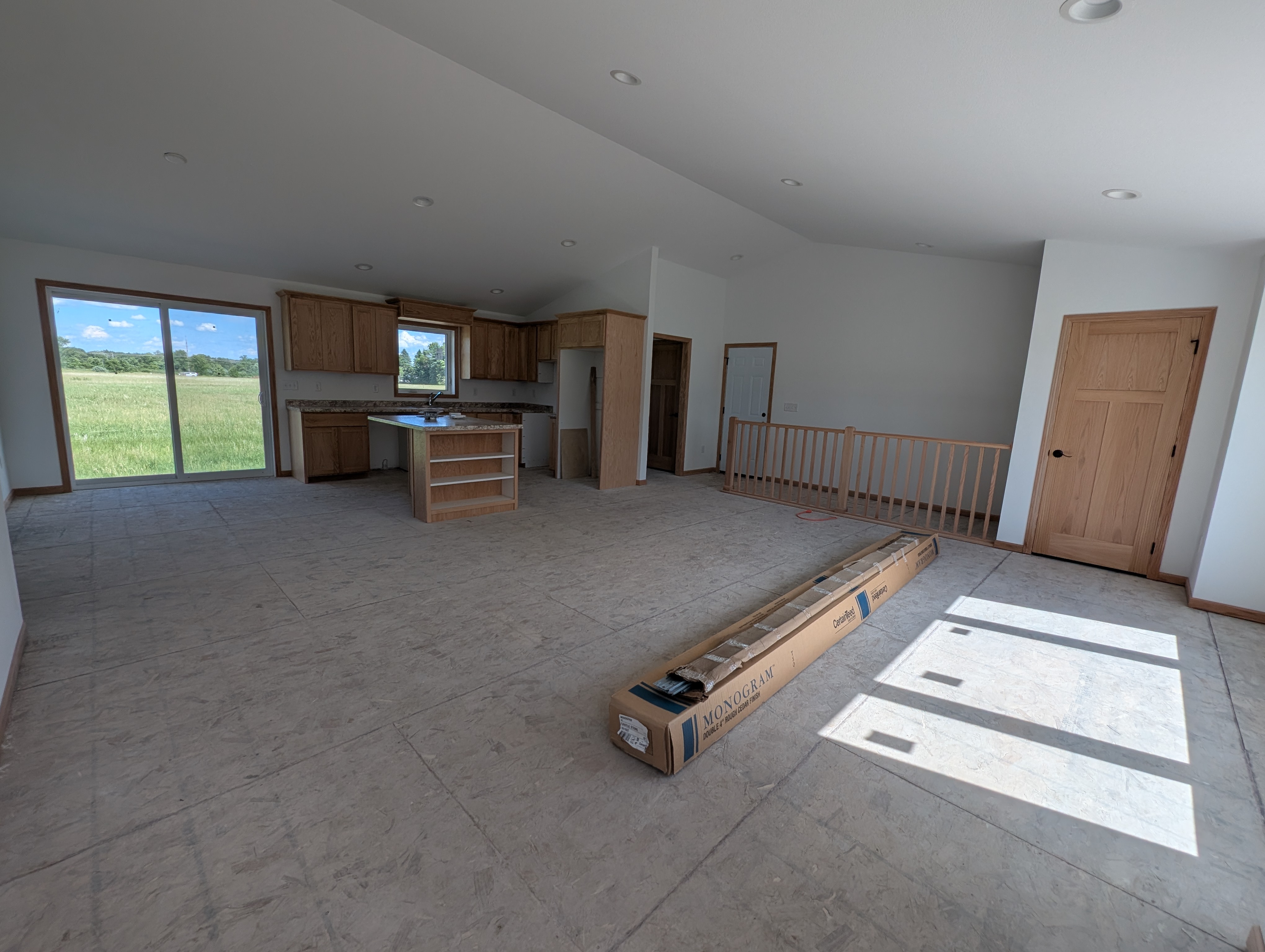 Open concept living room, kitchen, and dining area.