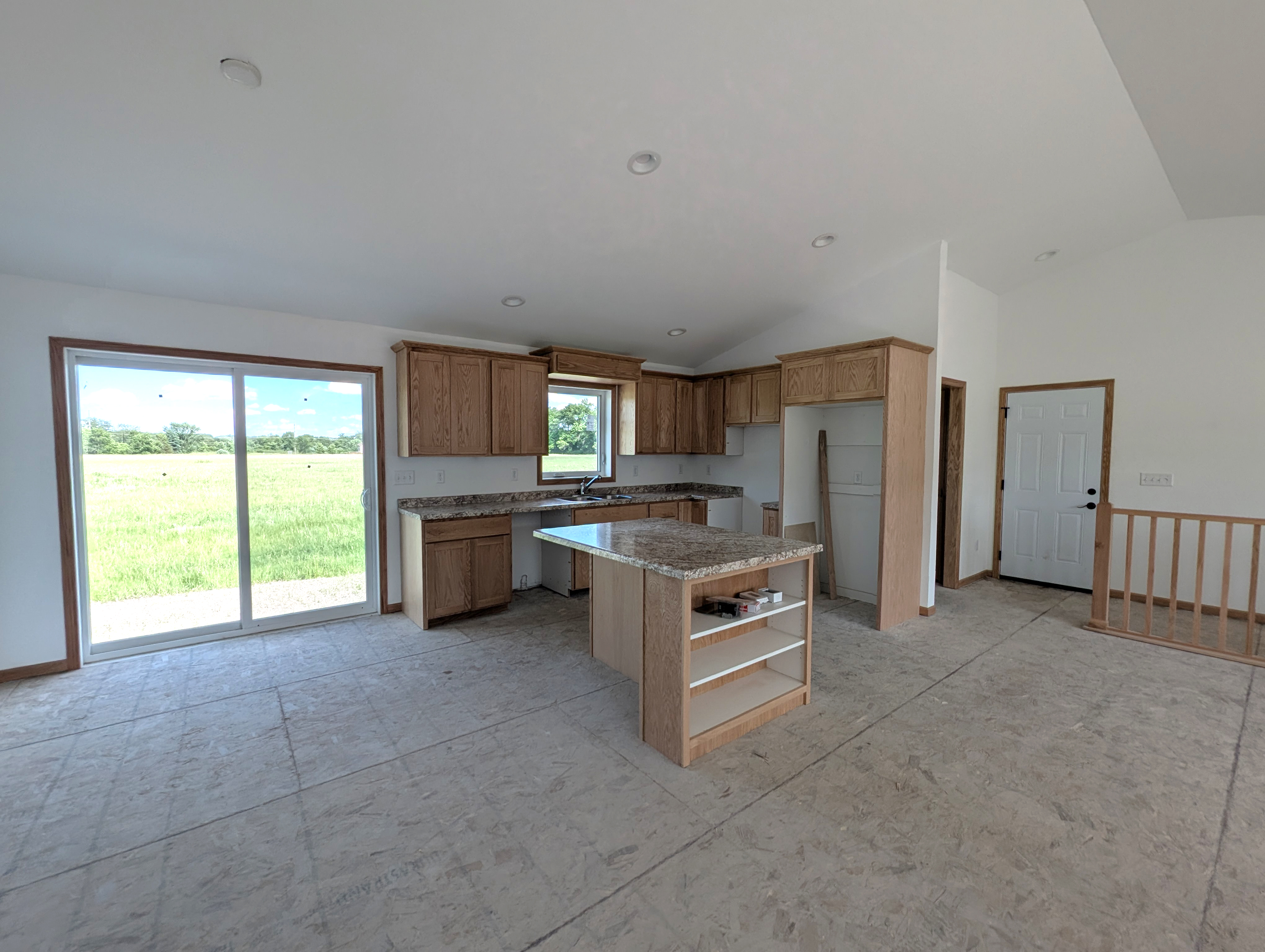 Kitchen and dining area with patio door.