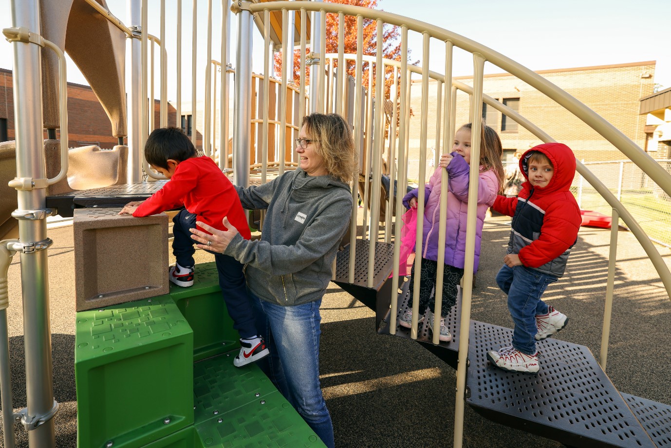 Preschool-age children playing on playground equipment